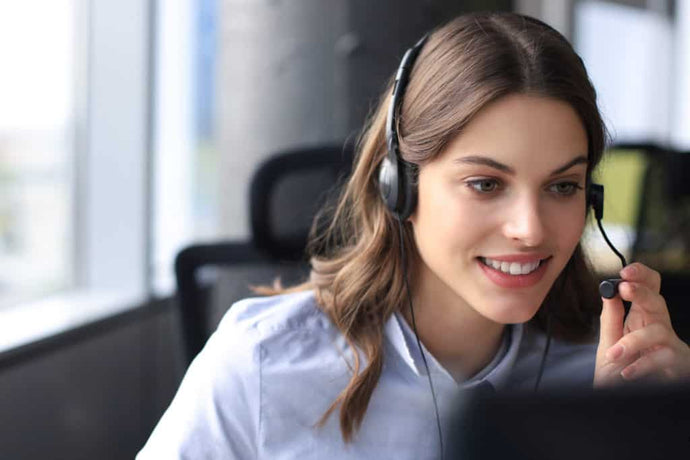 Female customer support wearing a headset and handling customer inquiries.