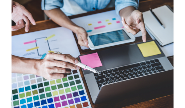Image of employees discussing a design.