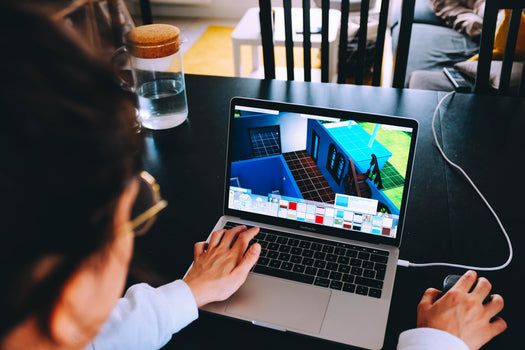 Image of an employee working on design using a laptop.