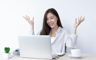 Retail business owner monitoring omnichannel business performance on a laptop from home.
