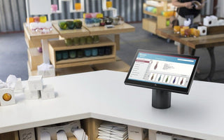 HP POS system monitor on a retail checkout counter.