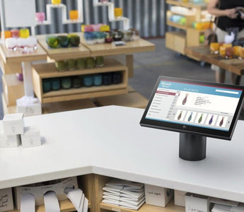 HP POS system monitor on a retail checkout counter.