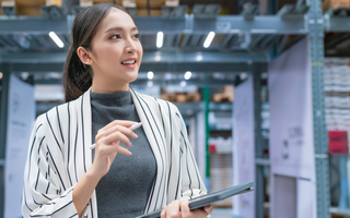 Warehouse manager using a warehouse management system to monitor operations.