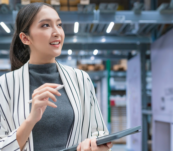 Warehouse manager using a warehouse management system to monitor operations.