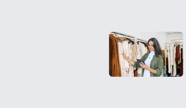 clothing store owner using tablet to check stock levels.